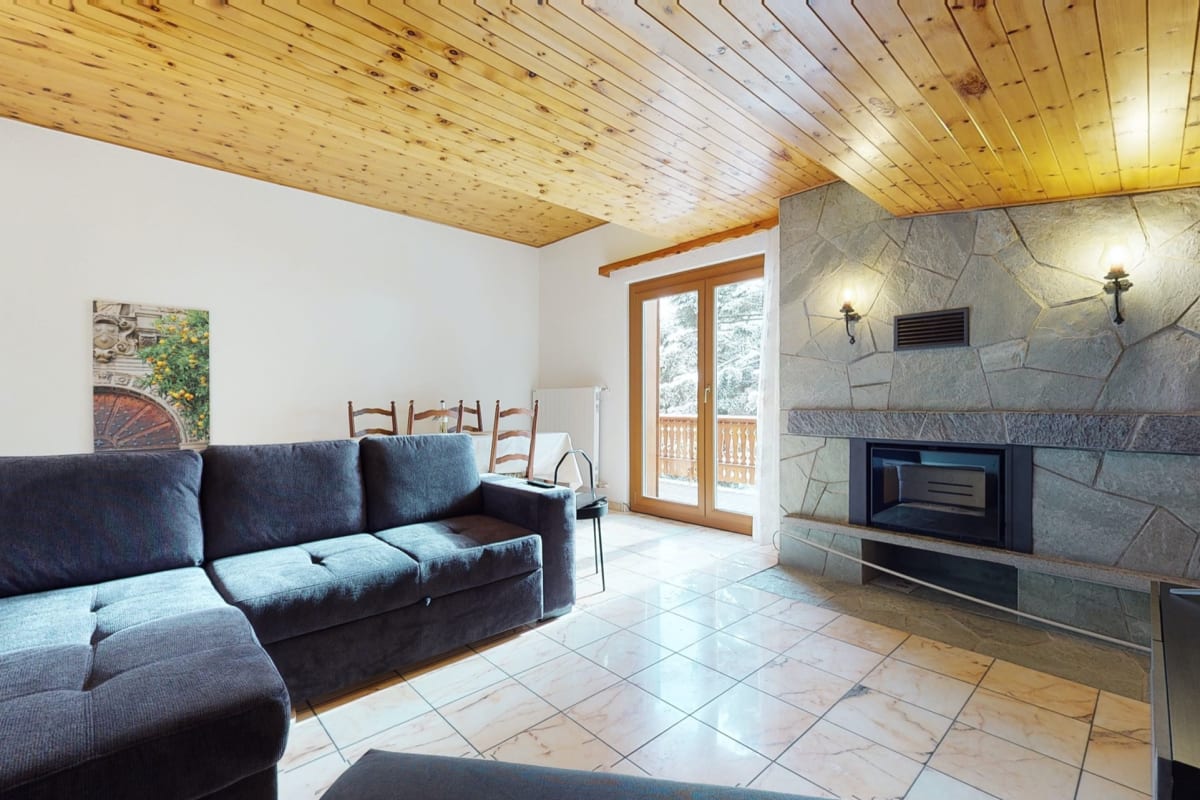 Wohnzimmer mit Kamin und Holzbalkendecke