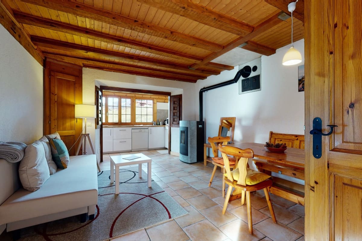 Gemütliches Wohn-Esszimmer mit offener Küche und Holzdecke