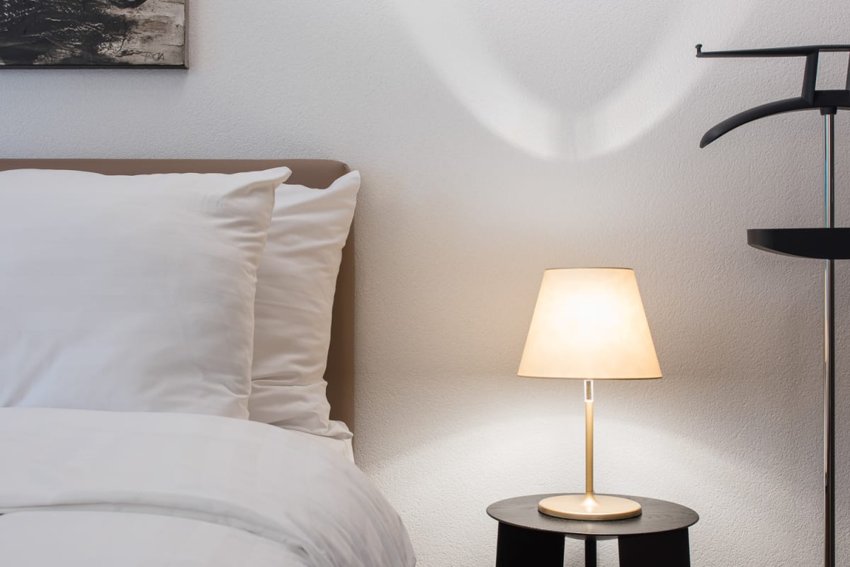 Gemütliches Schlafzimmerdetail mit Nachttischlampe