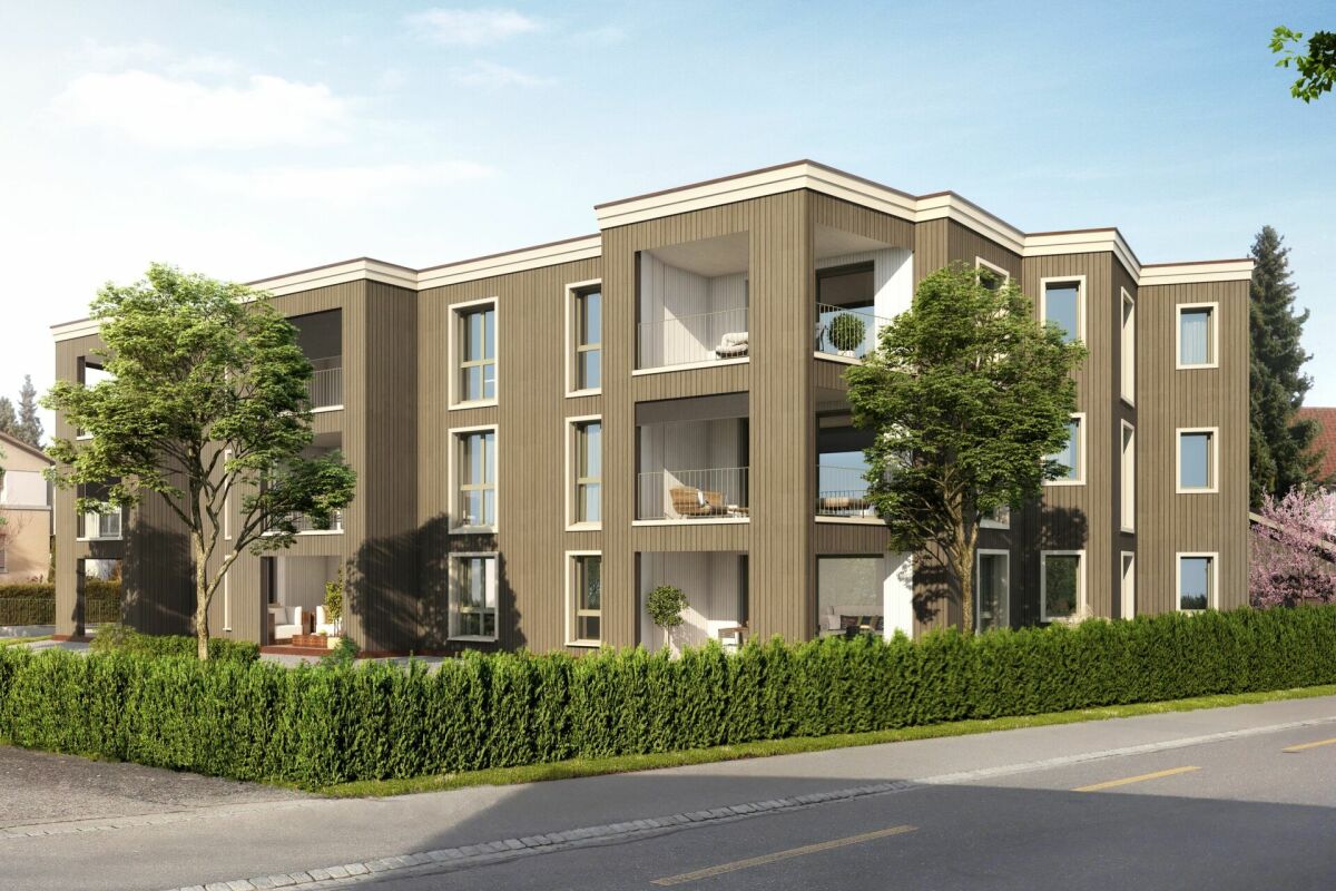 Modernes Mehrfamilienhaus mit begrüntem Straßenrand