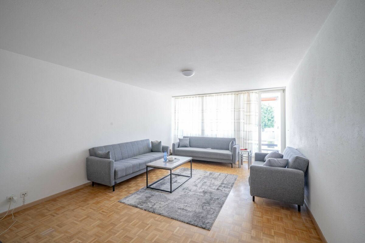 Helles Wohnzimmer mit drei grauen Sofas