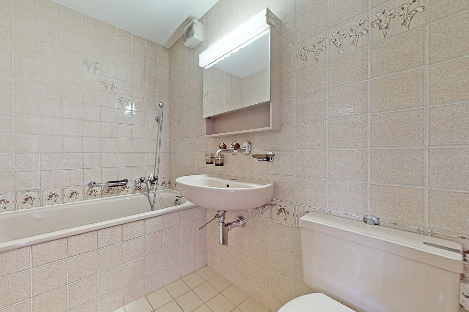 Kleines Badezimmer mit Badewanne und WC