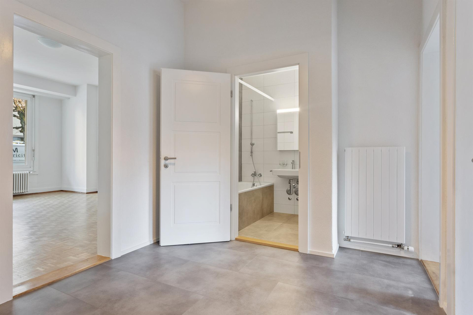 Heller Flur mit Blick ins Bad und Zimmer