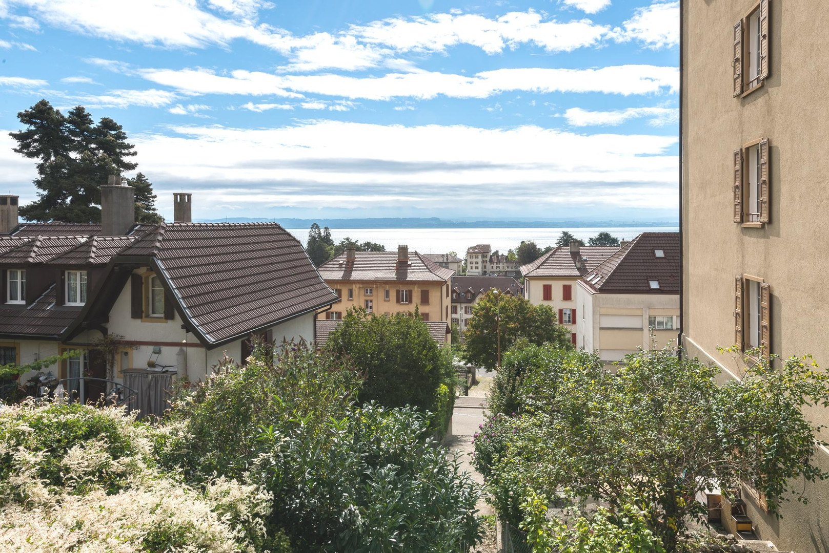 Seeblick über Wohnhäuser und Garten