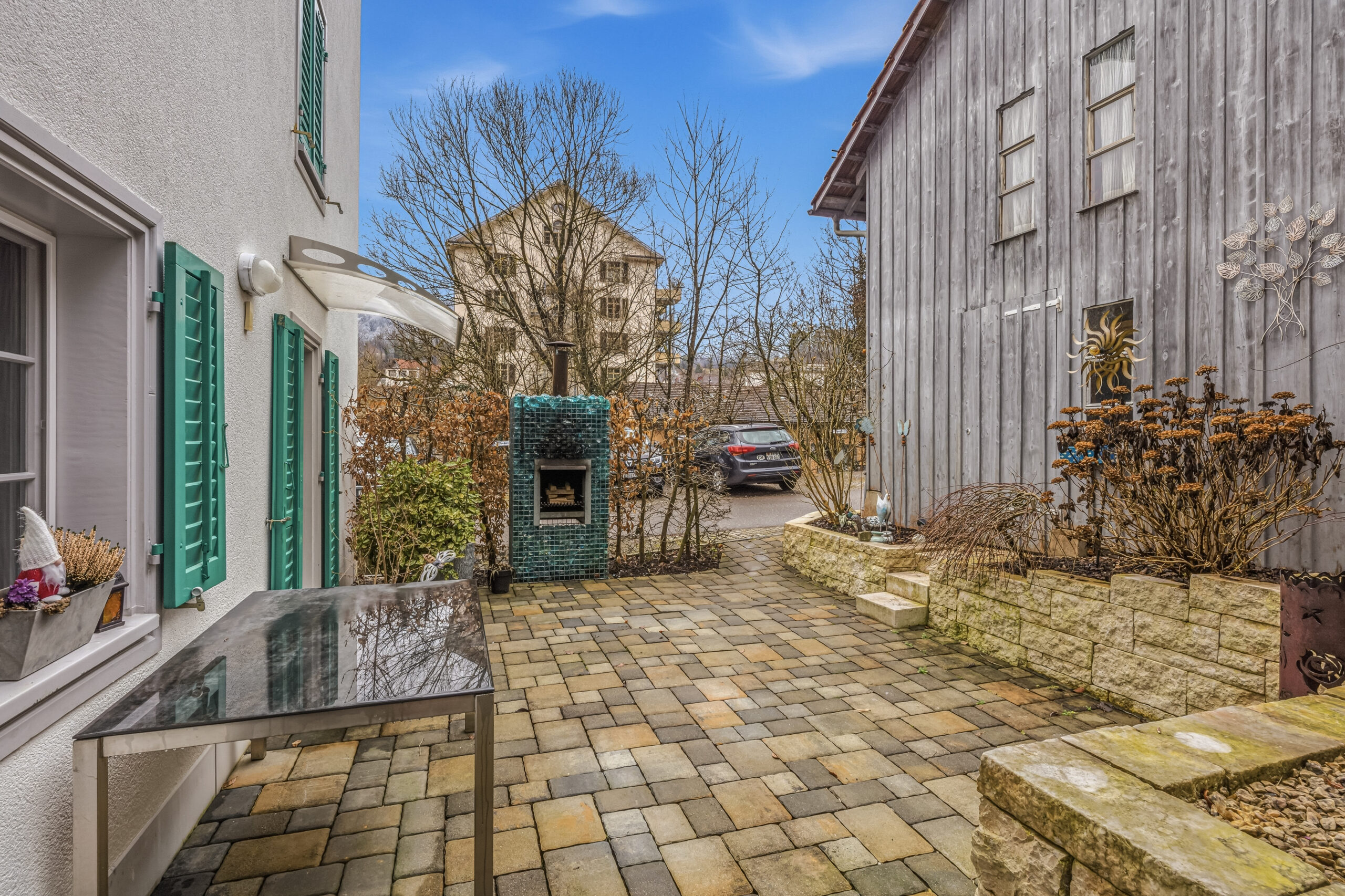 Innenhof mit gepflasterter Terrasse zwischen zwei Gebäuden