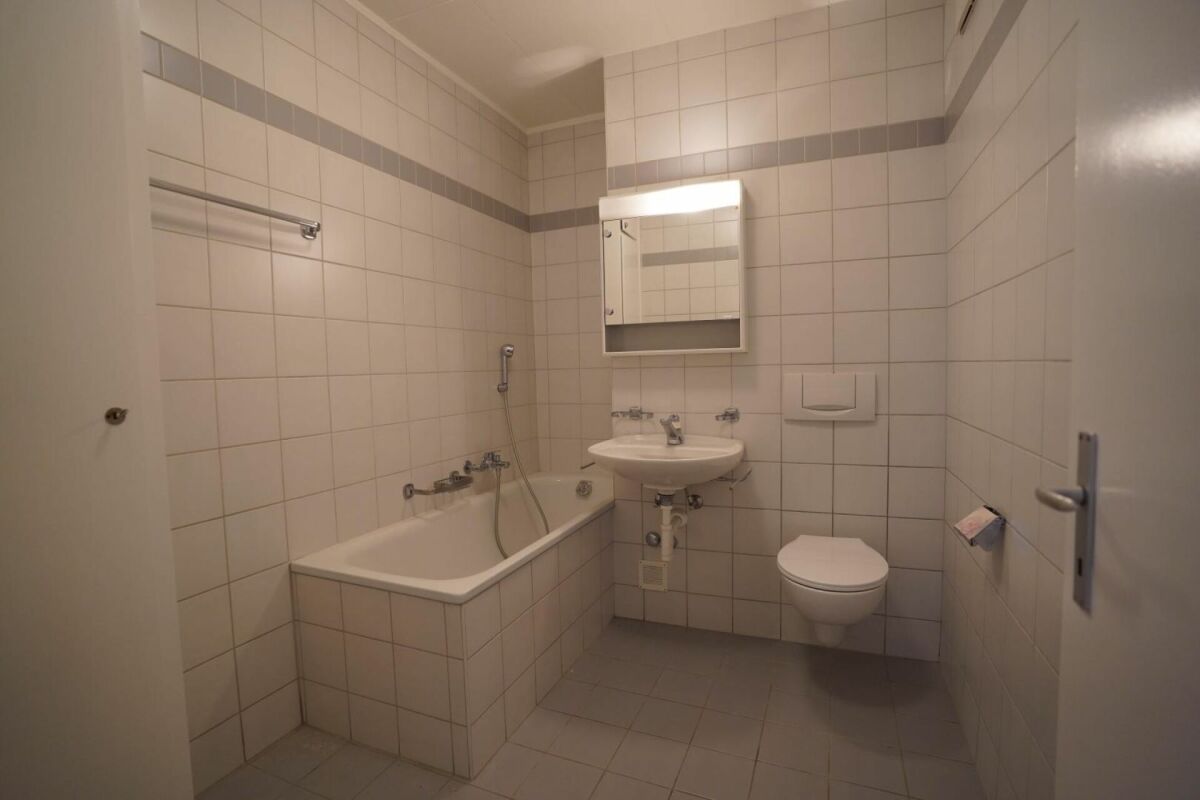 Kleines gefliestes Badezimmer mit Wanne und WC