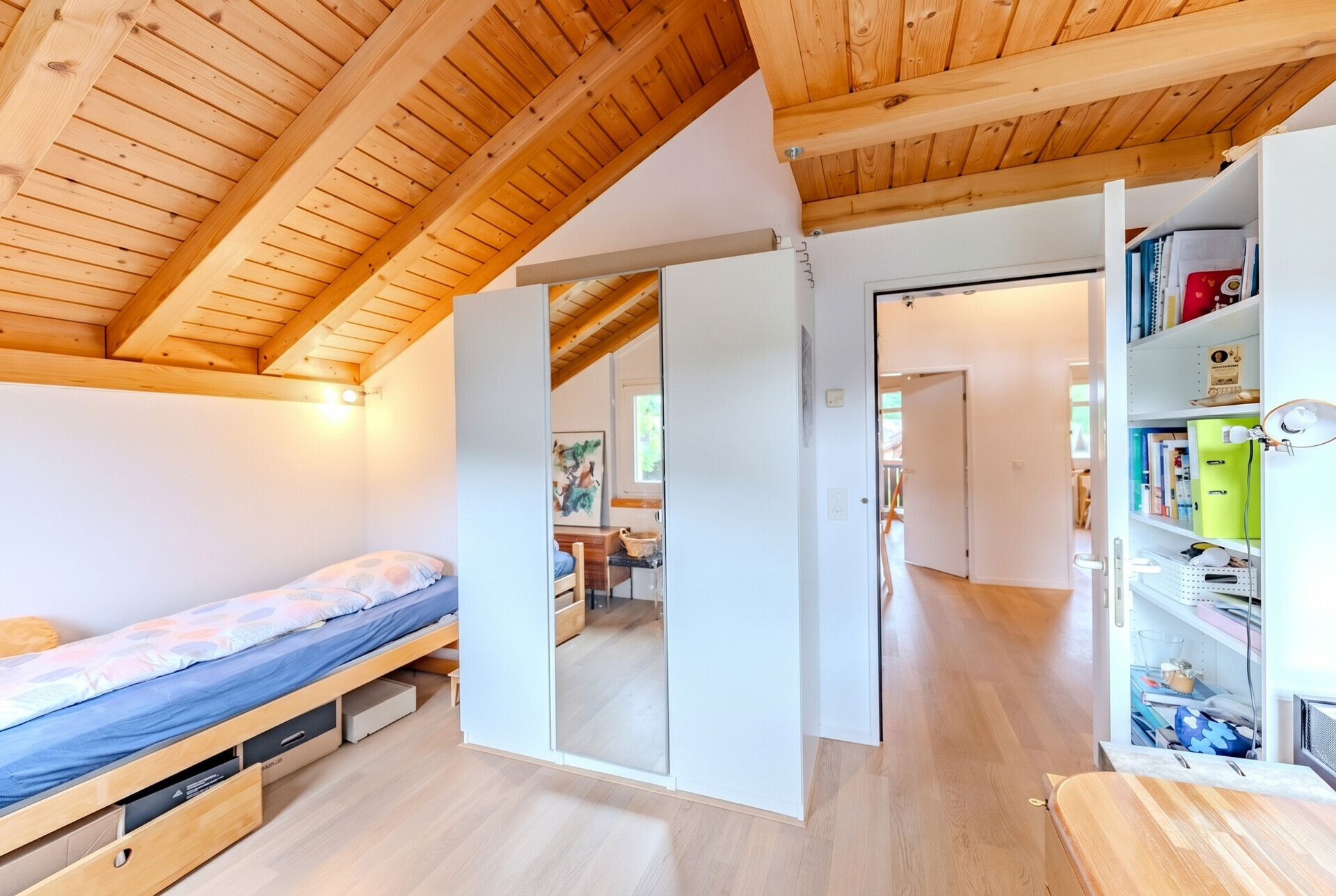 Dachzimmer mit Bett und Stauraum
