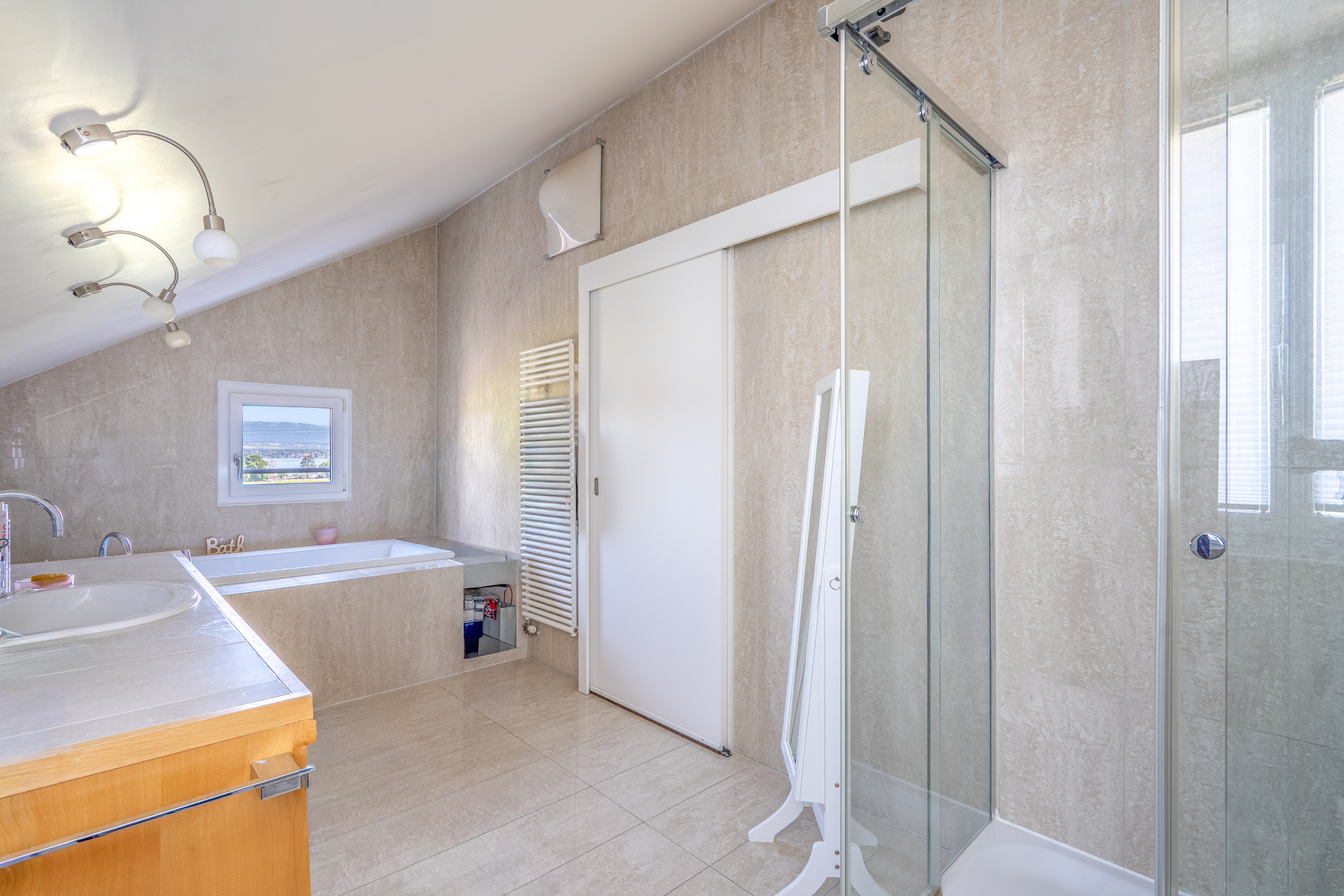 Helles Dachgeschoss-Badezimmer mit Dusche und Badewanne
