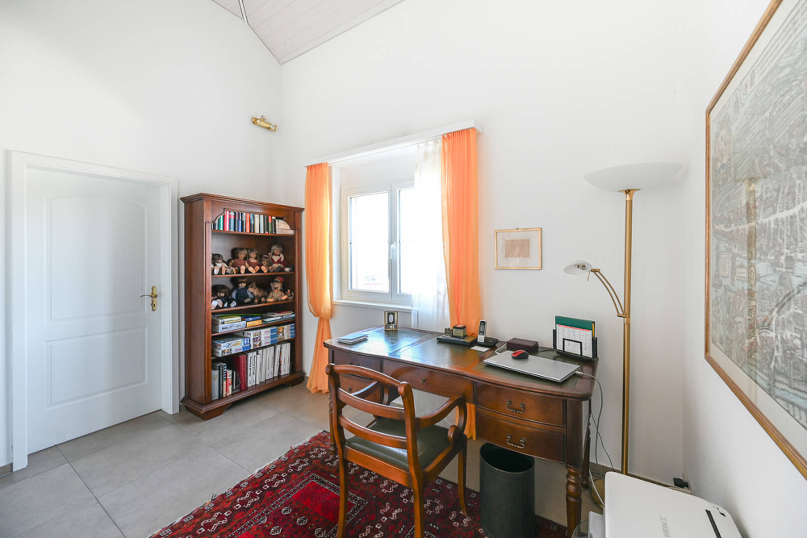 Helles Arbeitszimmer mit Schreibtisch und Regal