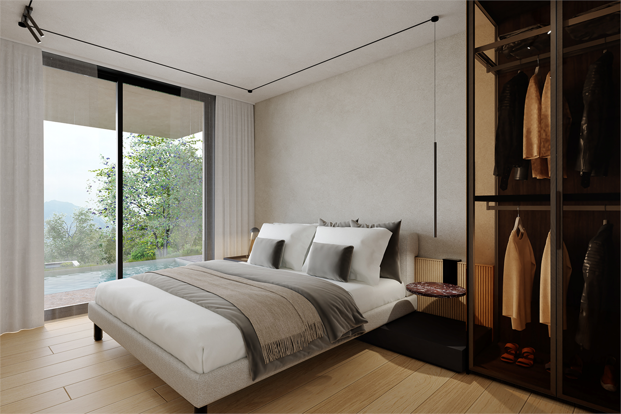 Modernes Schlafzimmer mit Ankleide und Blick ins Grüne