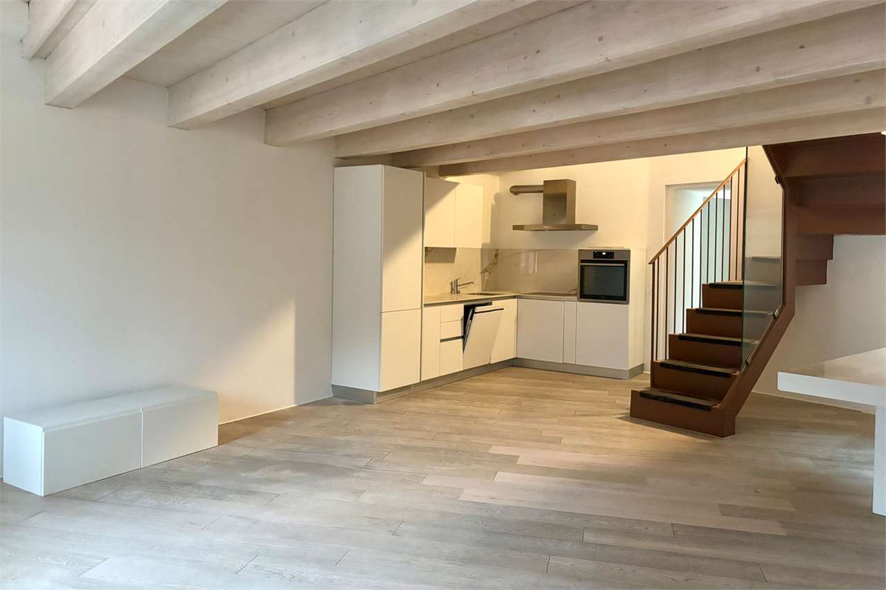 Offener Wohnbereich mit Küche und Treppe