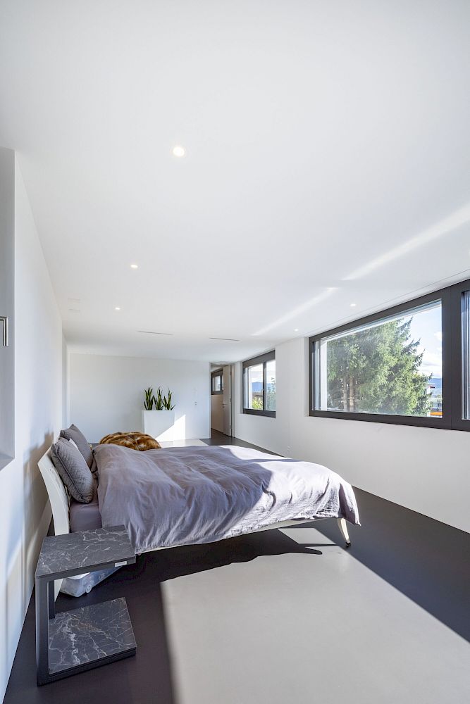 Modernes Schlafzimmer mit großen Fenstern
