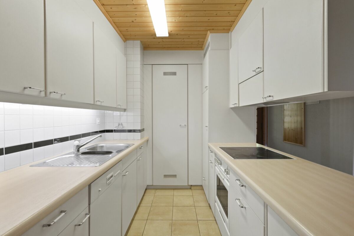Schmale, helle Küche mit Holzdecke