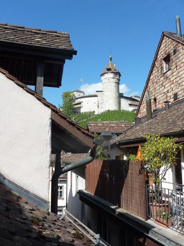 Blick auf mittelalterliche Festungsanlage zwischen eng stehenden Dächern