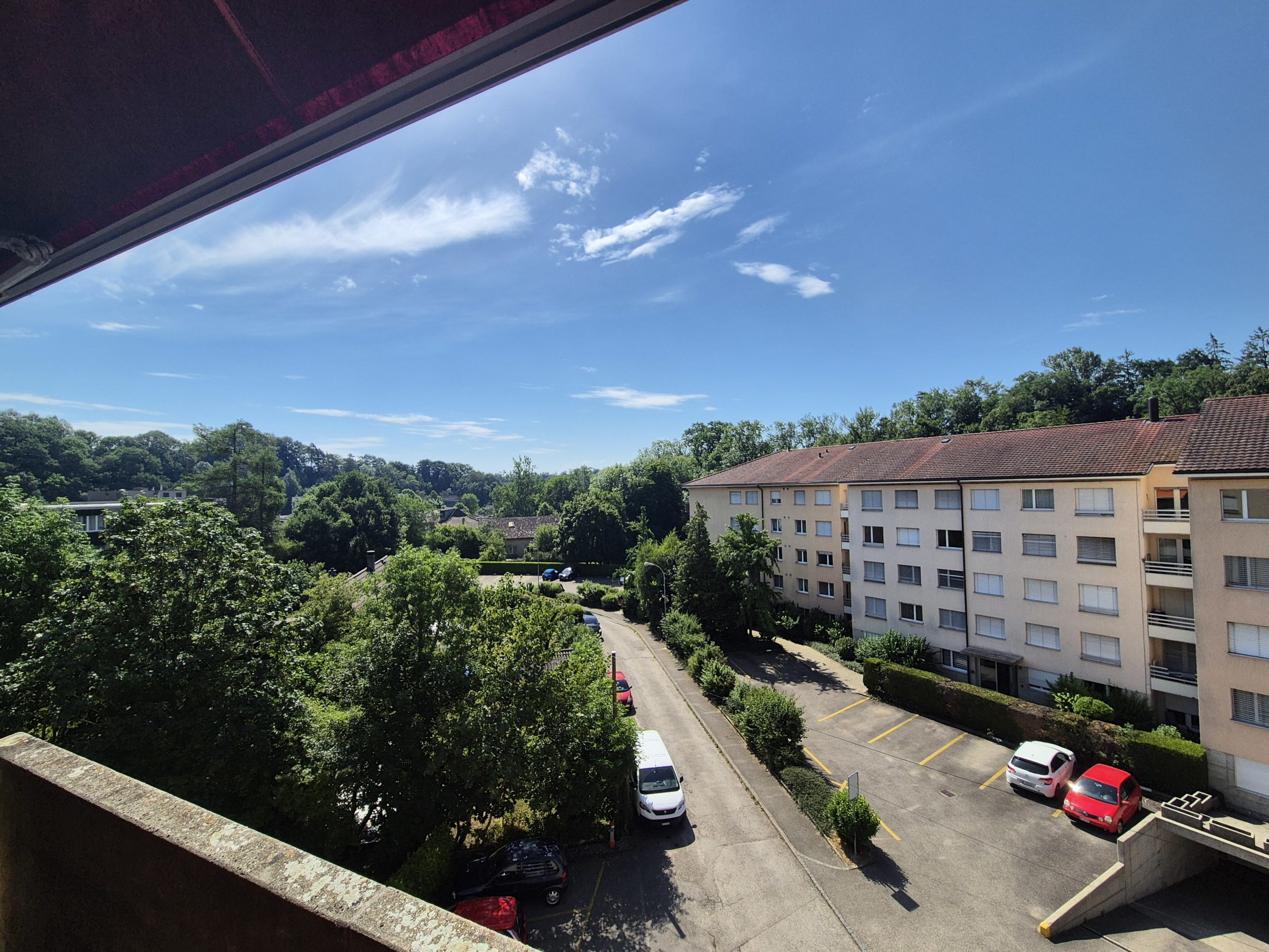 Blick vom Balkon auf Wohnanlage und Grünflächen