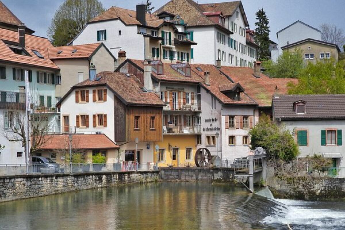 Uferhäuser an einem kleinen Fluss mit Wehr