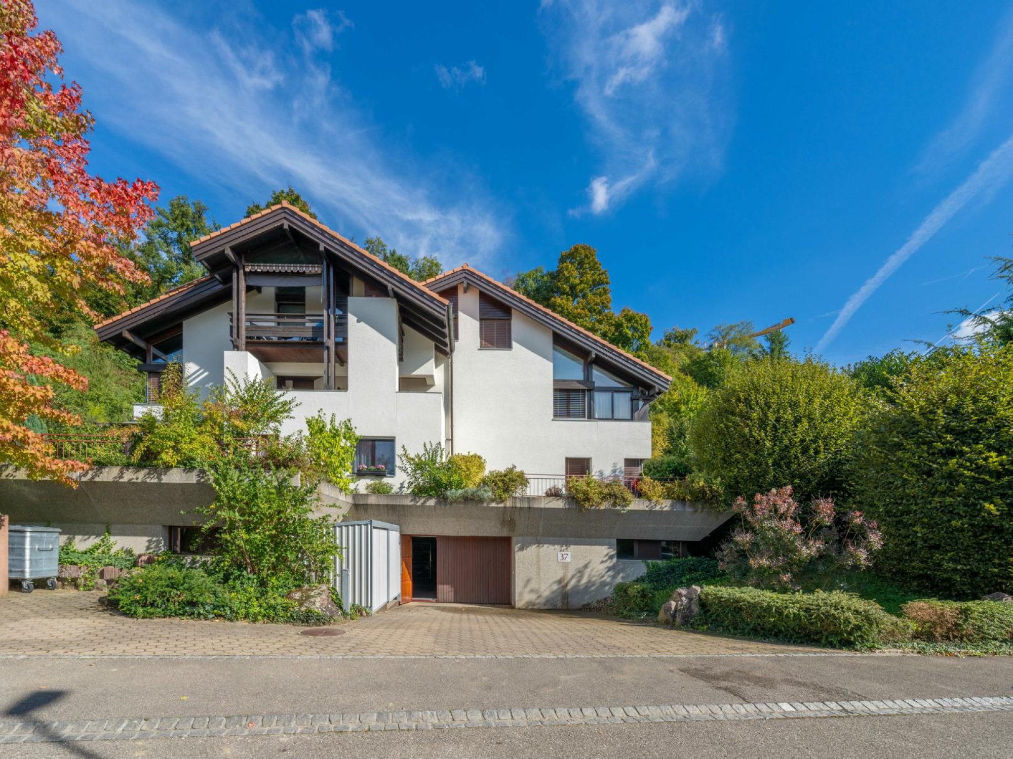 Freistehendes Haus mit steilem Satteldach und Garten