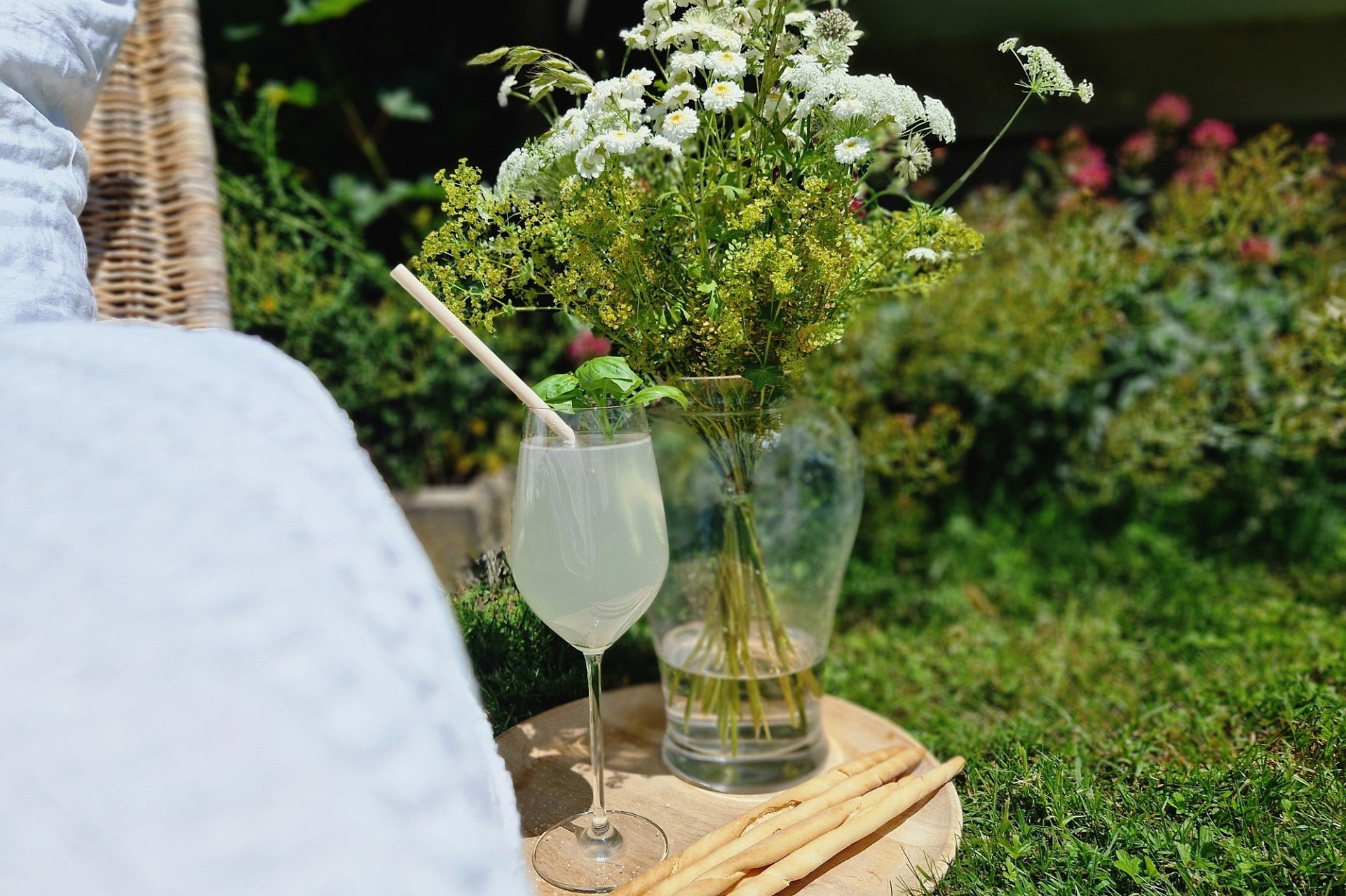 Garten-Picknick mit Getränk und Blumen