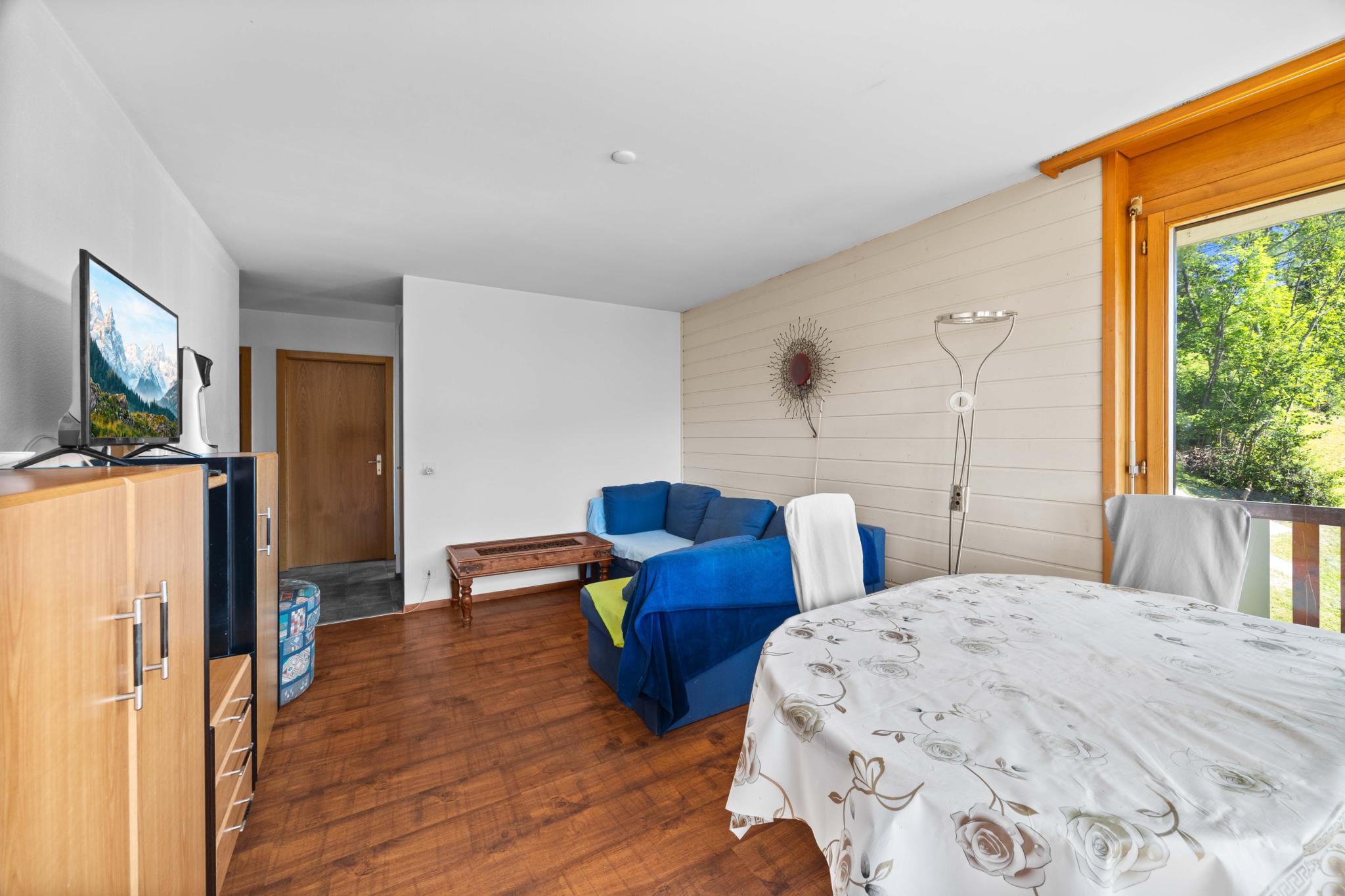 Helles Schlafzimmer mit Holzfußboden und Balkonblick
