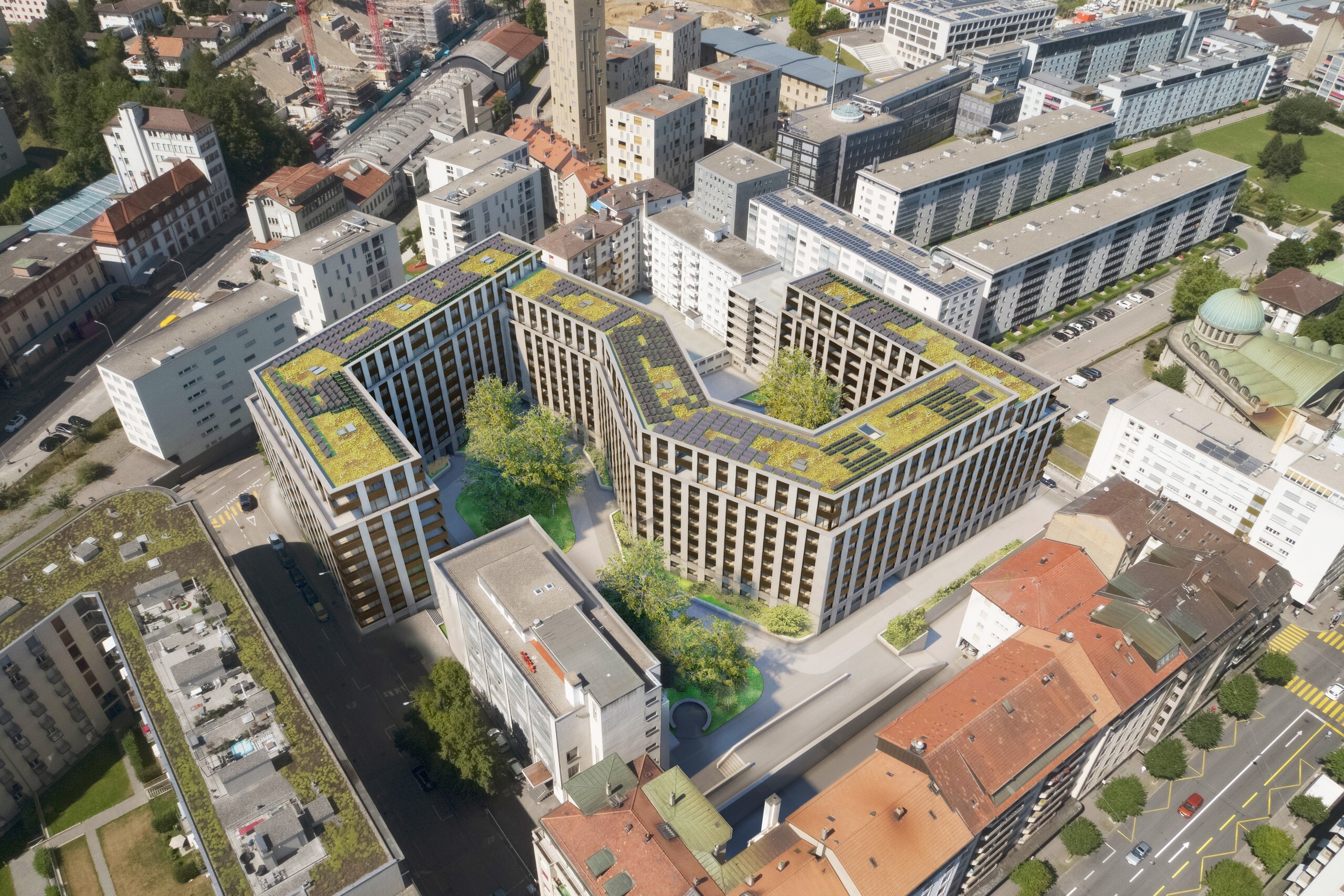 Luftaufnahme eines modernen Wohnblocks mit begrünten Dächern