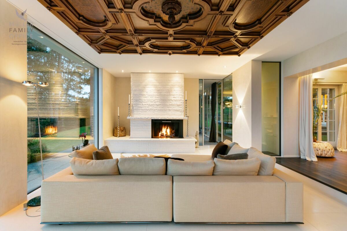 Luxuriöses Wohnzimmer mit Kamin und großer Fensterfront
