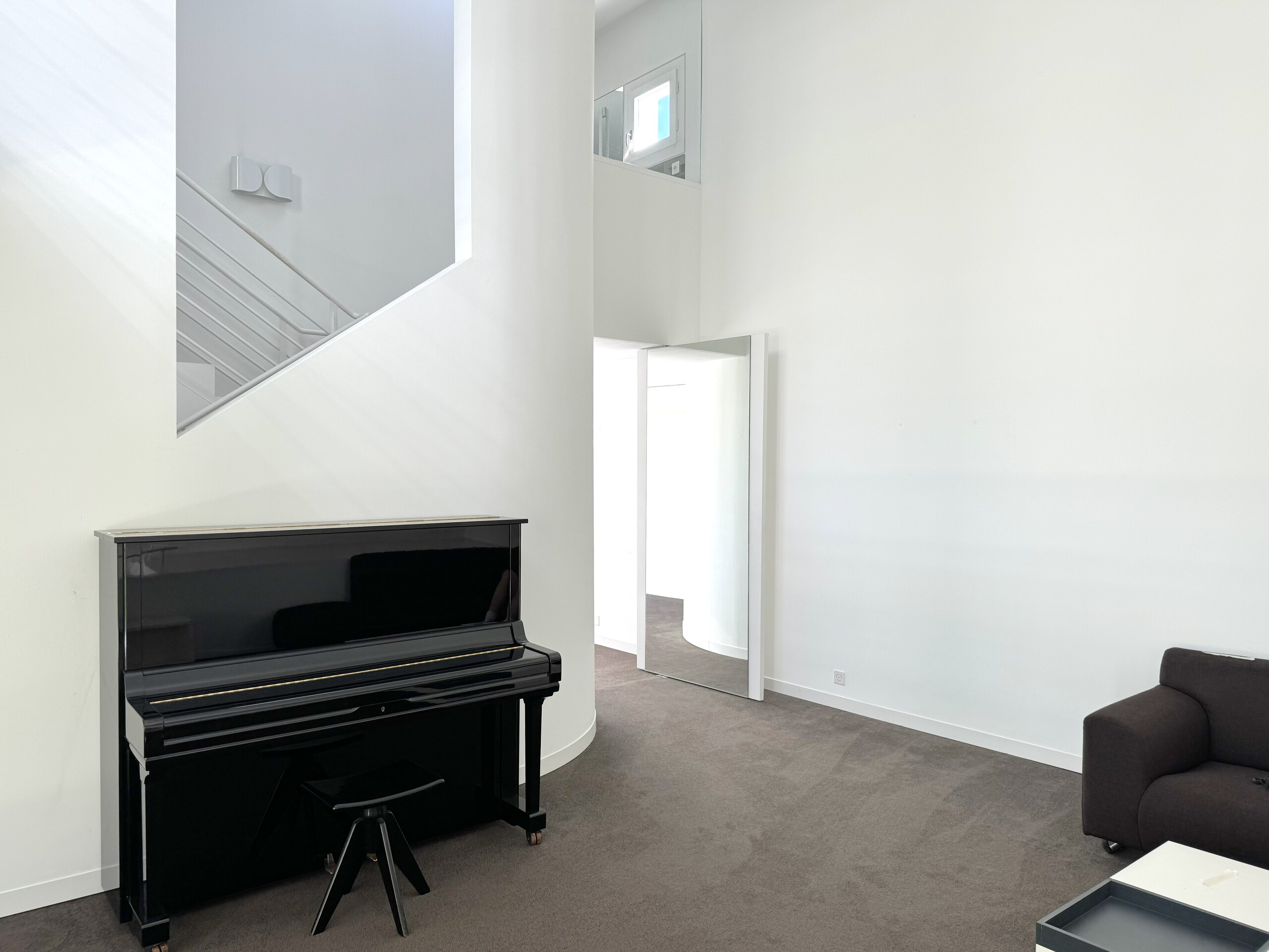 Modernes Wohn-/Musikzimmer mit offenem Treppenbereich