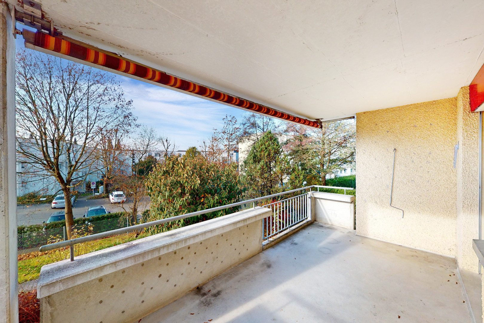 Überdachter Balkon mit Blick ins Wohnumfeld