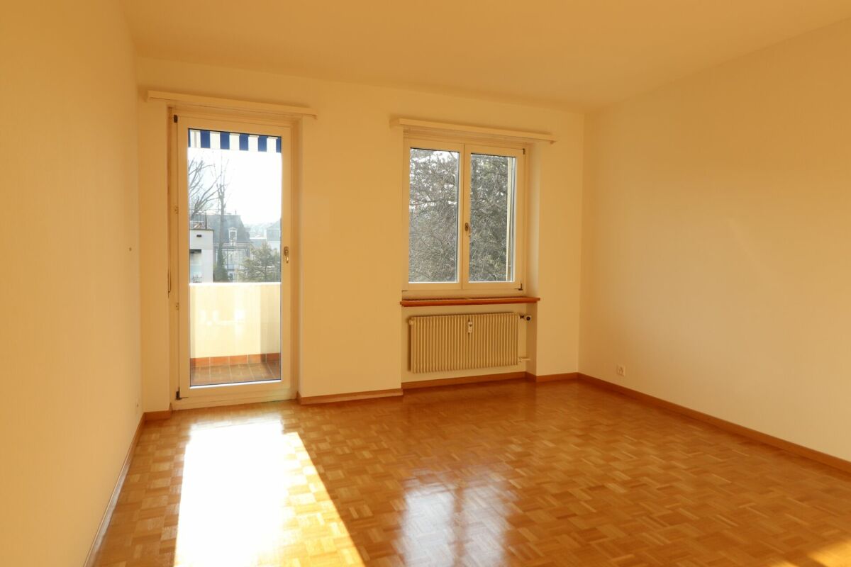 Leerer heller Wohnraum mit Balkon und Fenstern