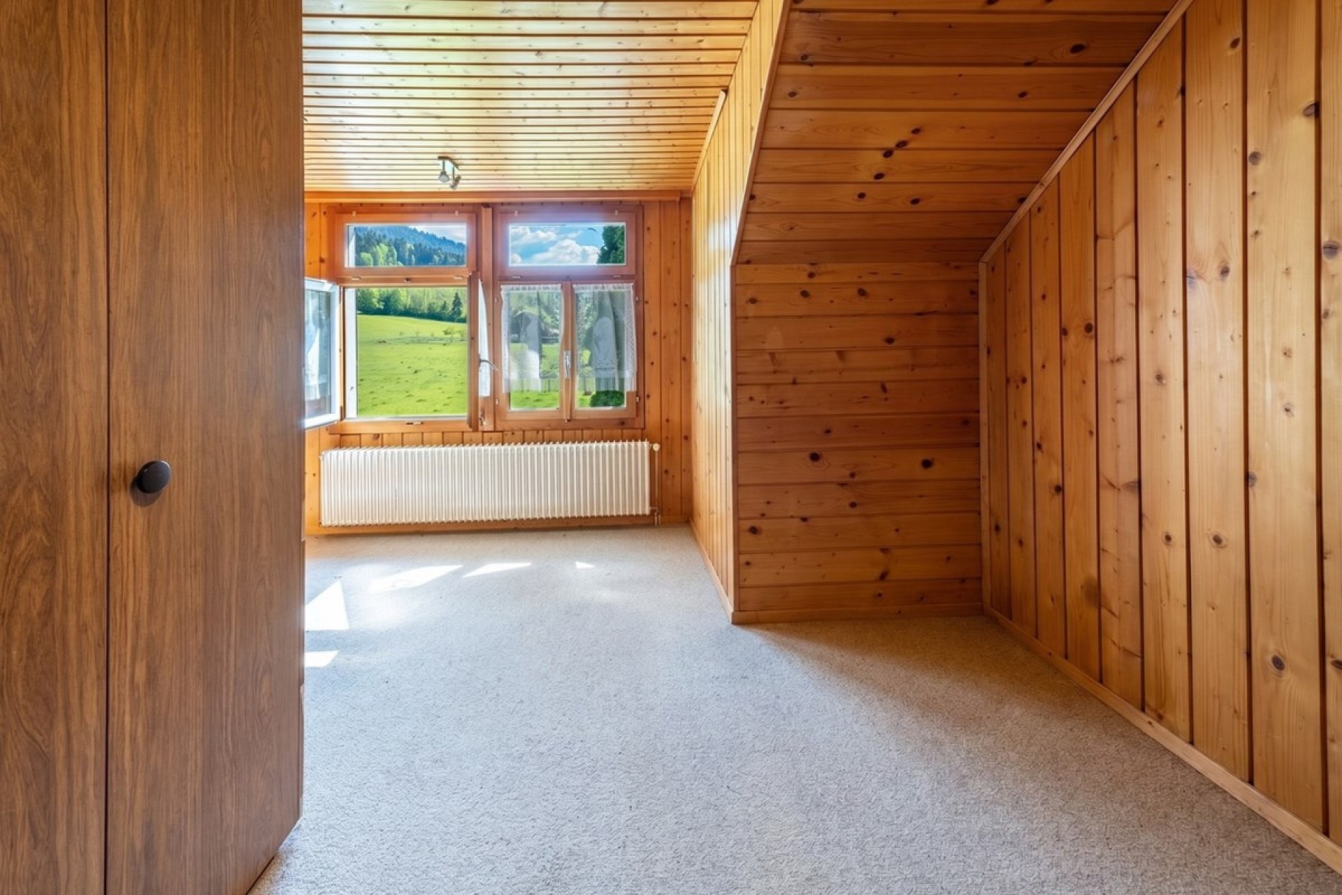 Holzvertäucherter Raum mit Blick ins Grüne