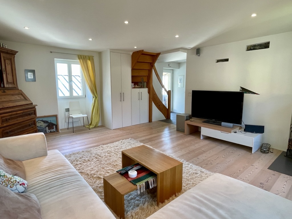 Heller Wohnraum mit Treppe und TV-Ecke