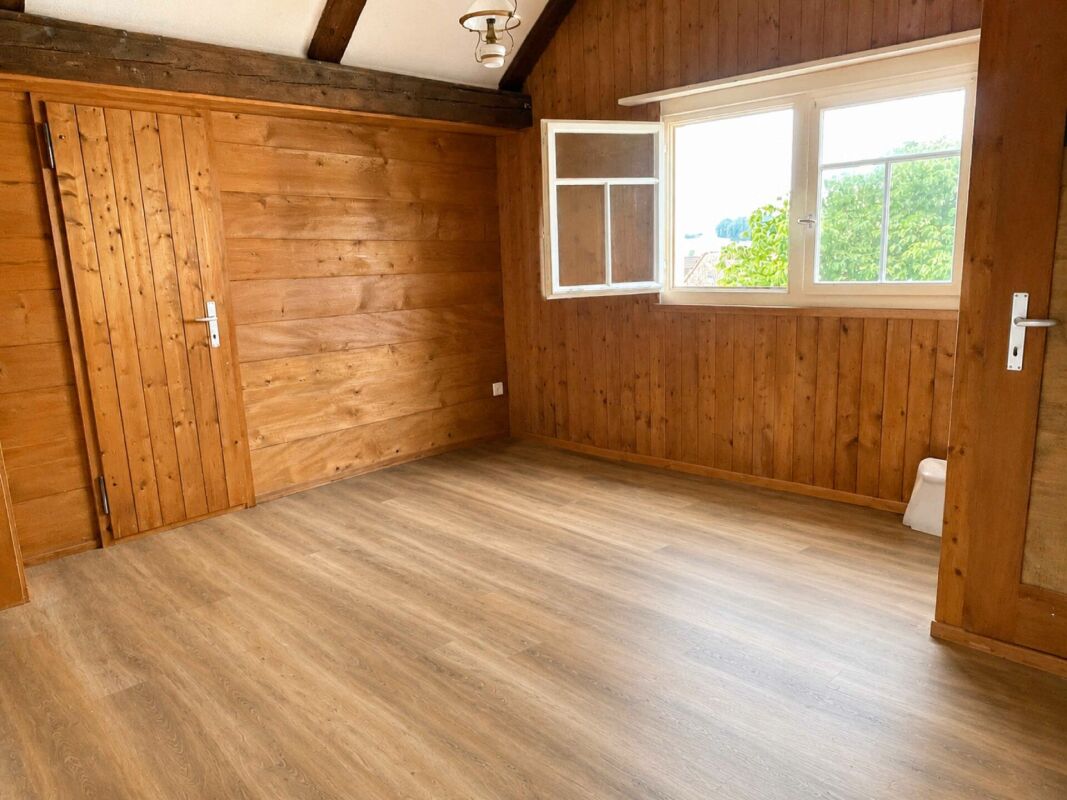Holzverkleideter Raum mit großem Fenster