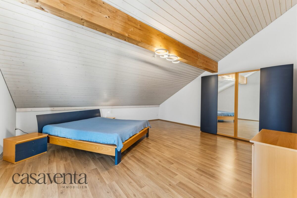 Dachgeschoss-Schlafzimmer mit Holzbalken