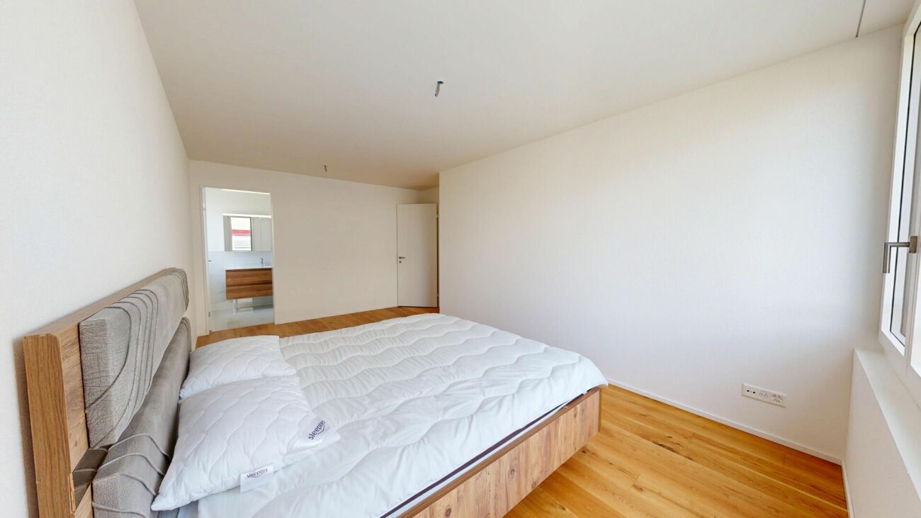 Schlafzimmer mit Doppelbett und Holzfußboden
