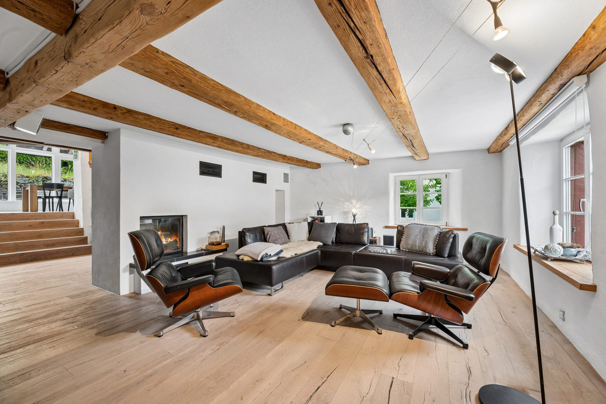 Wohnzimmer mit sichtbaren Holzbalken und Kamin