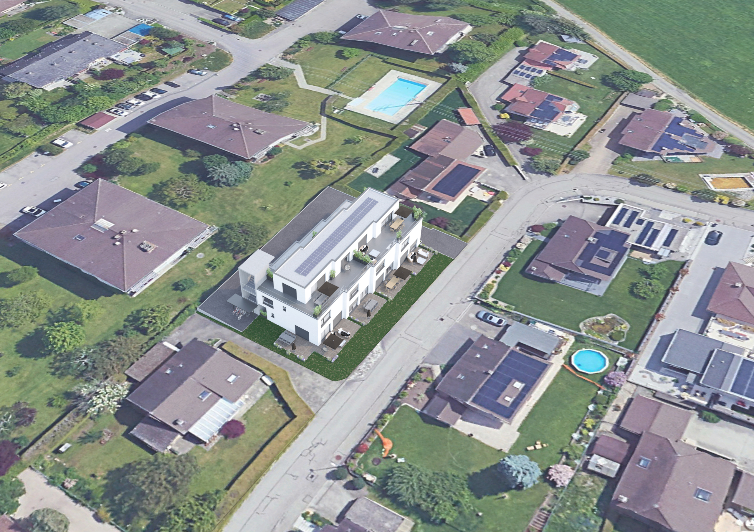 Luftaufnahme eines Wohnquartiers mit hervorgehobenem Neubau