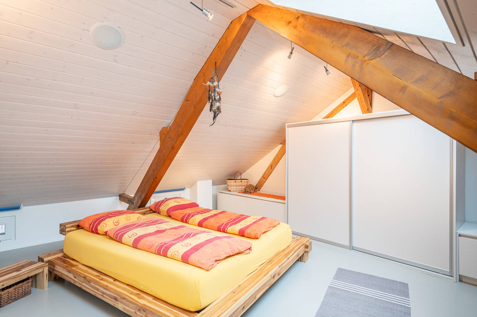 Dachgeschoss-Schlafzimmer mit Holzbalken