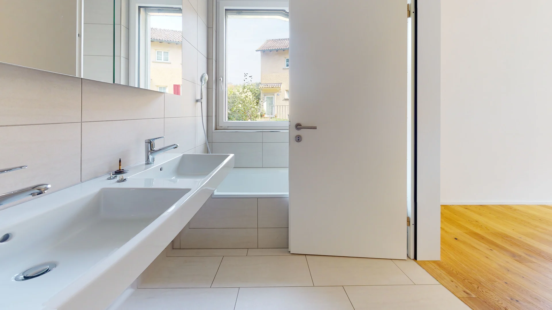 Helles Badezimmer mit Wanne und Doppelwaschtisch
