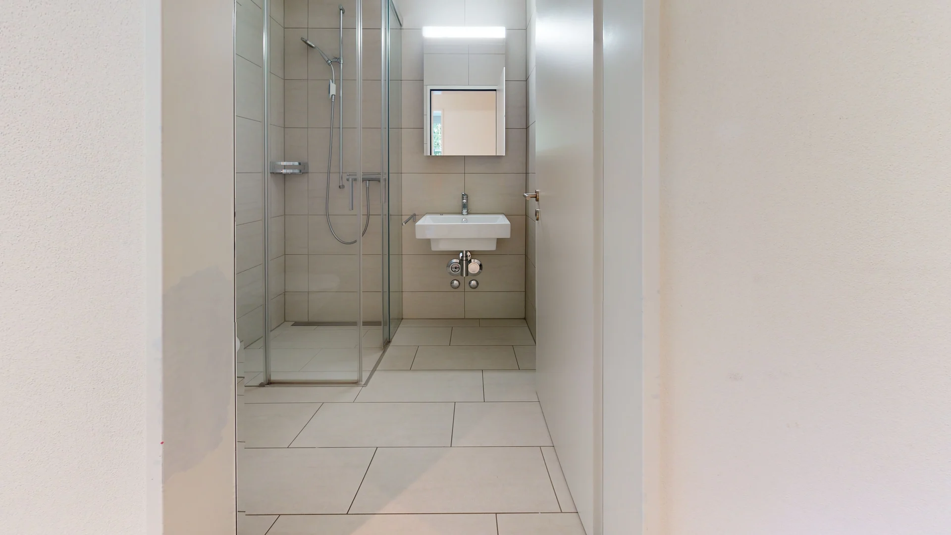 Helles Badezimmer mit Dusche und Waschtisch