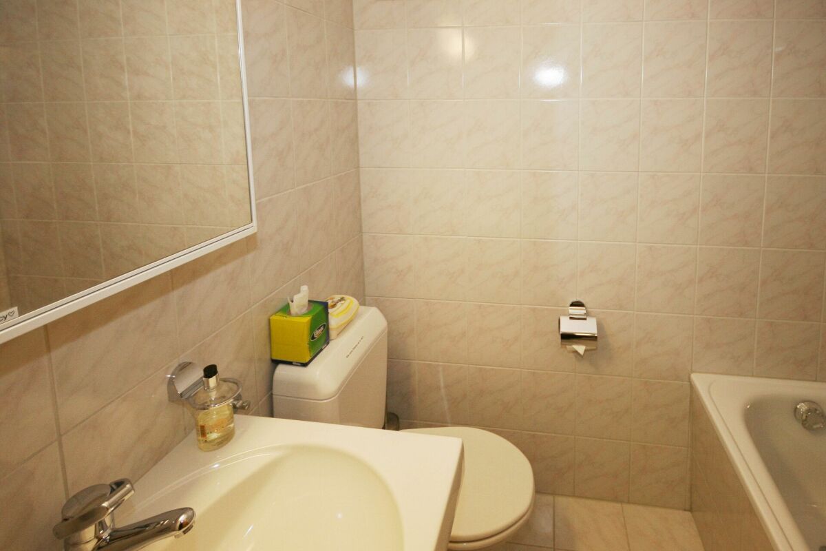 Kleines Badezimmer mit Badewanne und WC