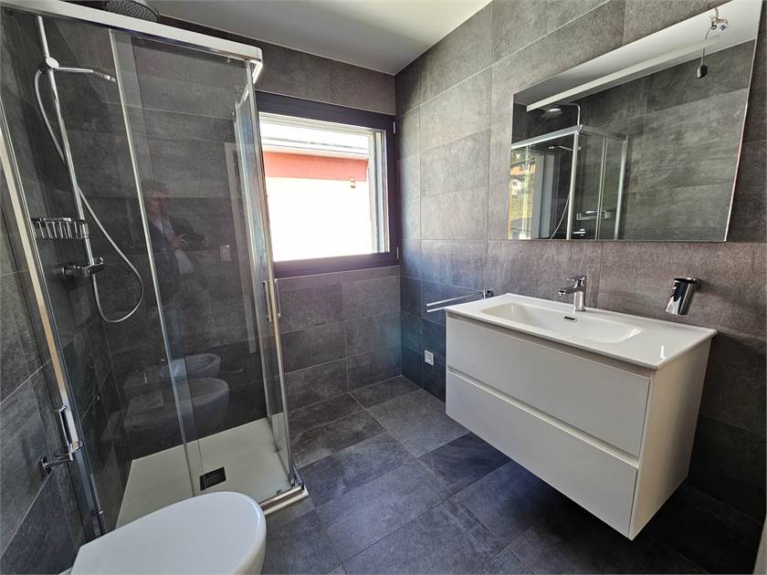 Modernes Badezimmer mit bodengleicher Dusche und Waschtisch