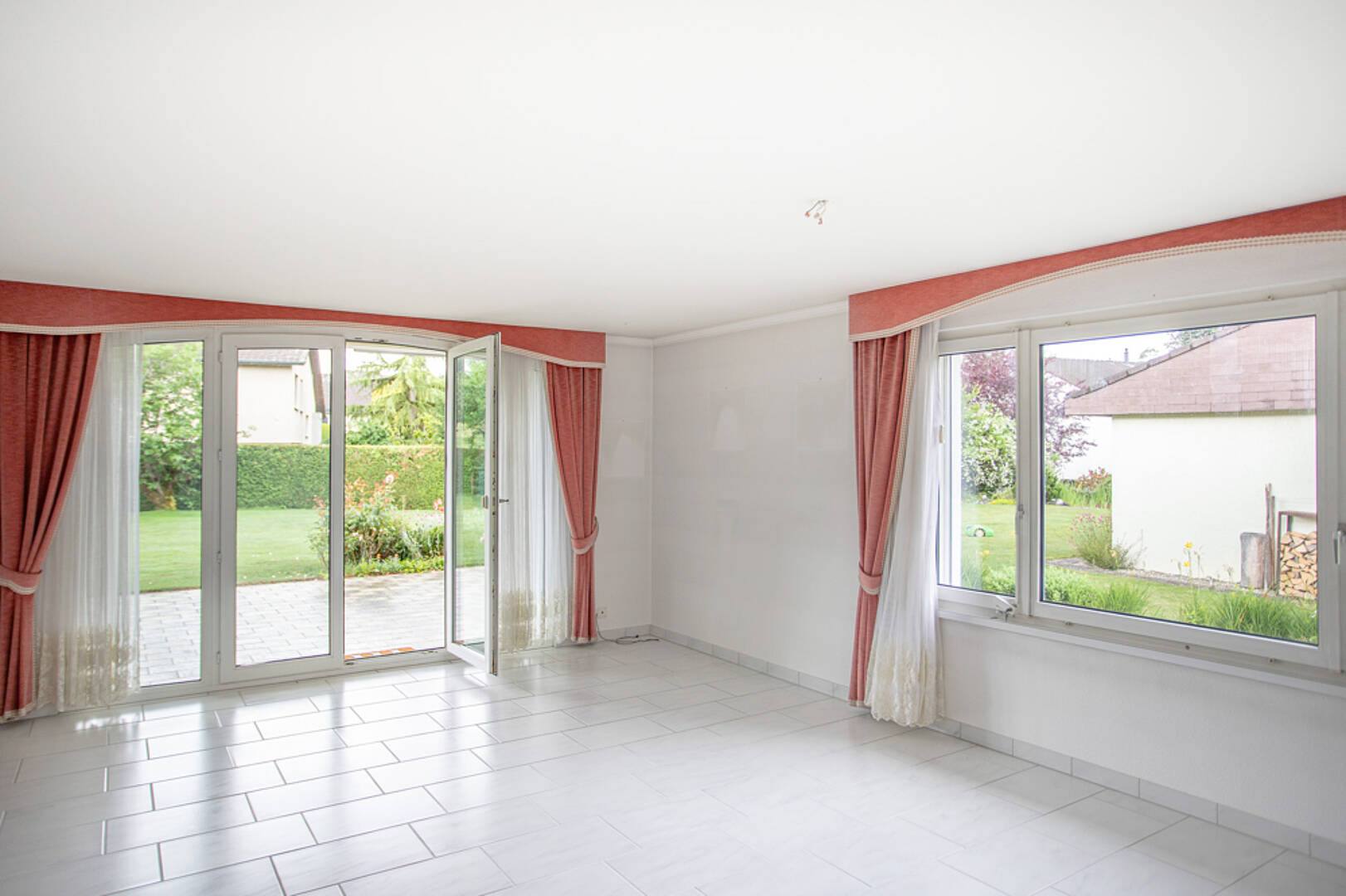 Heller Wohnraum mit Terrassentür und Gartenblick