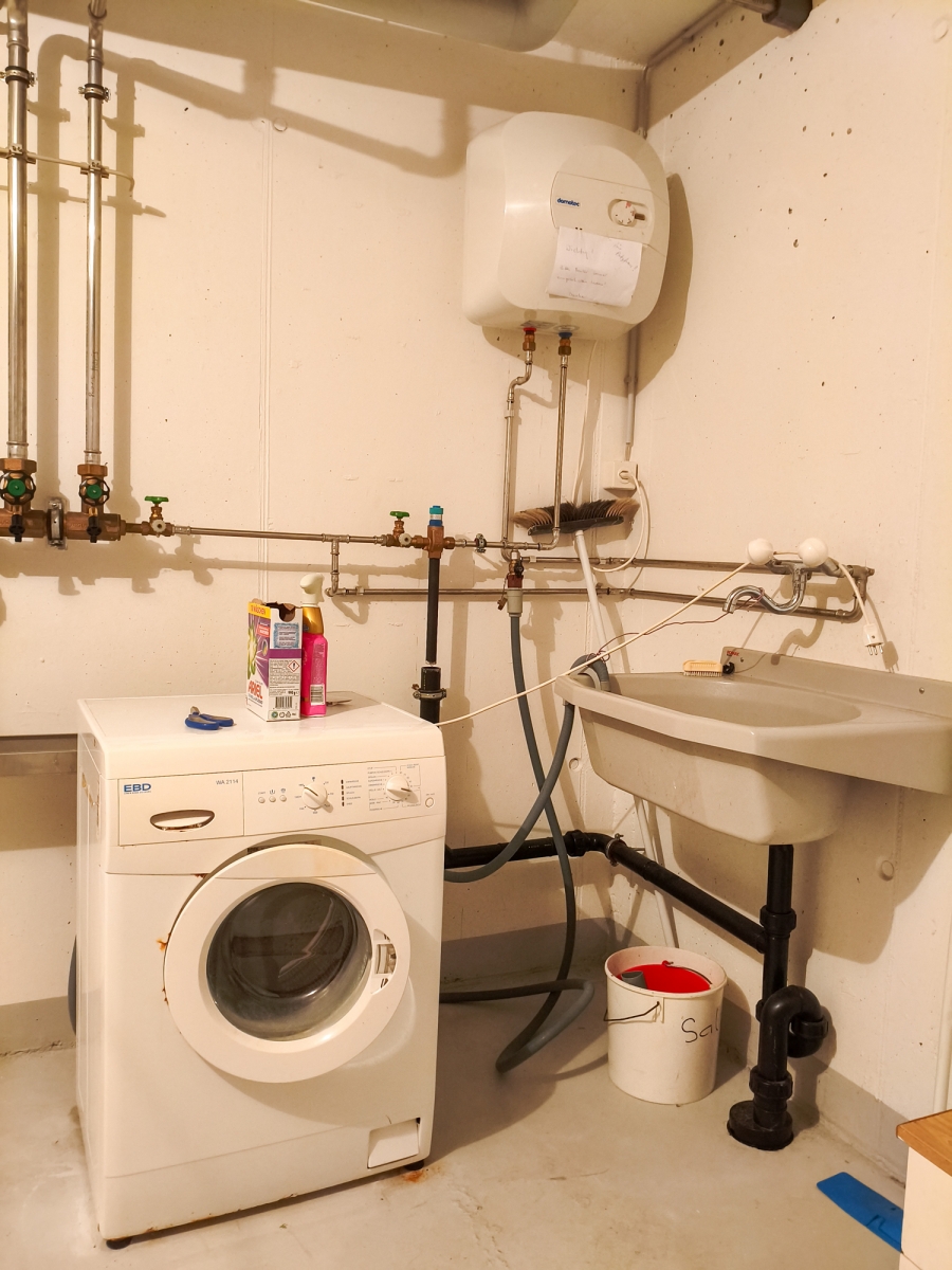 Hauswirtschaftsraum mit Waschmaschine und Technikinstallation