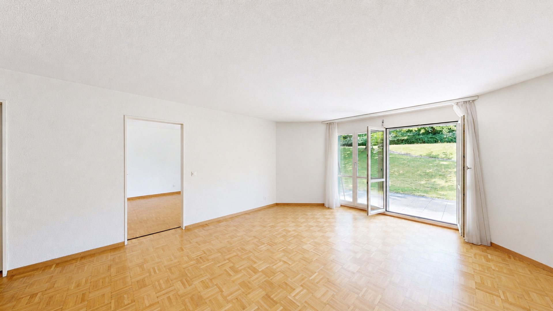 Heller leerer Wohnraum mit Gartenzugang