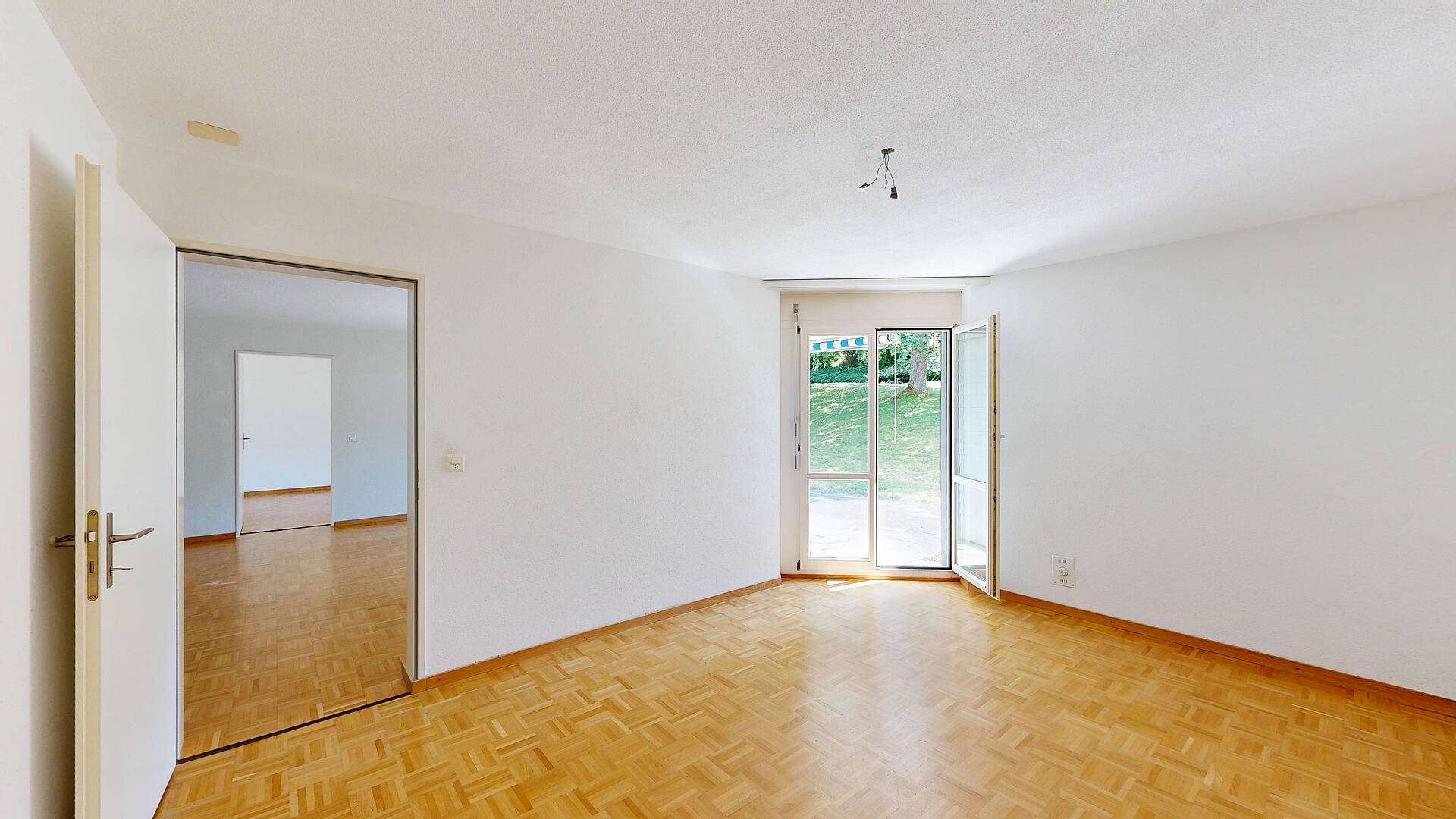 Heller leerer Wohnraum mit Balkonzugang