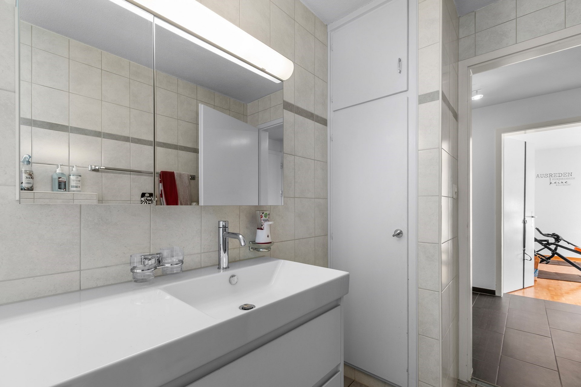 Helles Badezimmer mit Waschplatz und Spiegel
