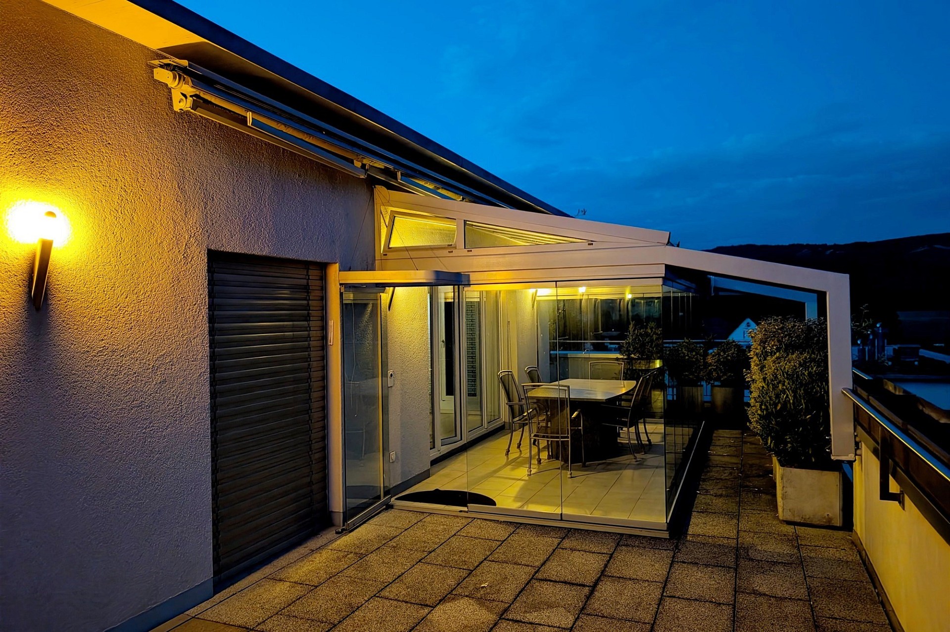 Überdachte Dachterrasse bei Dämmerung