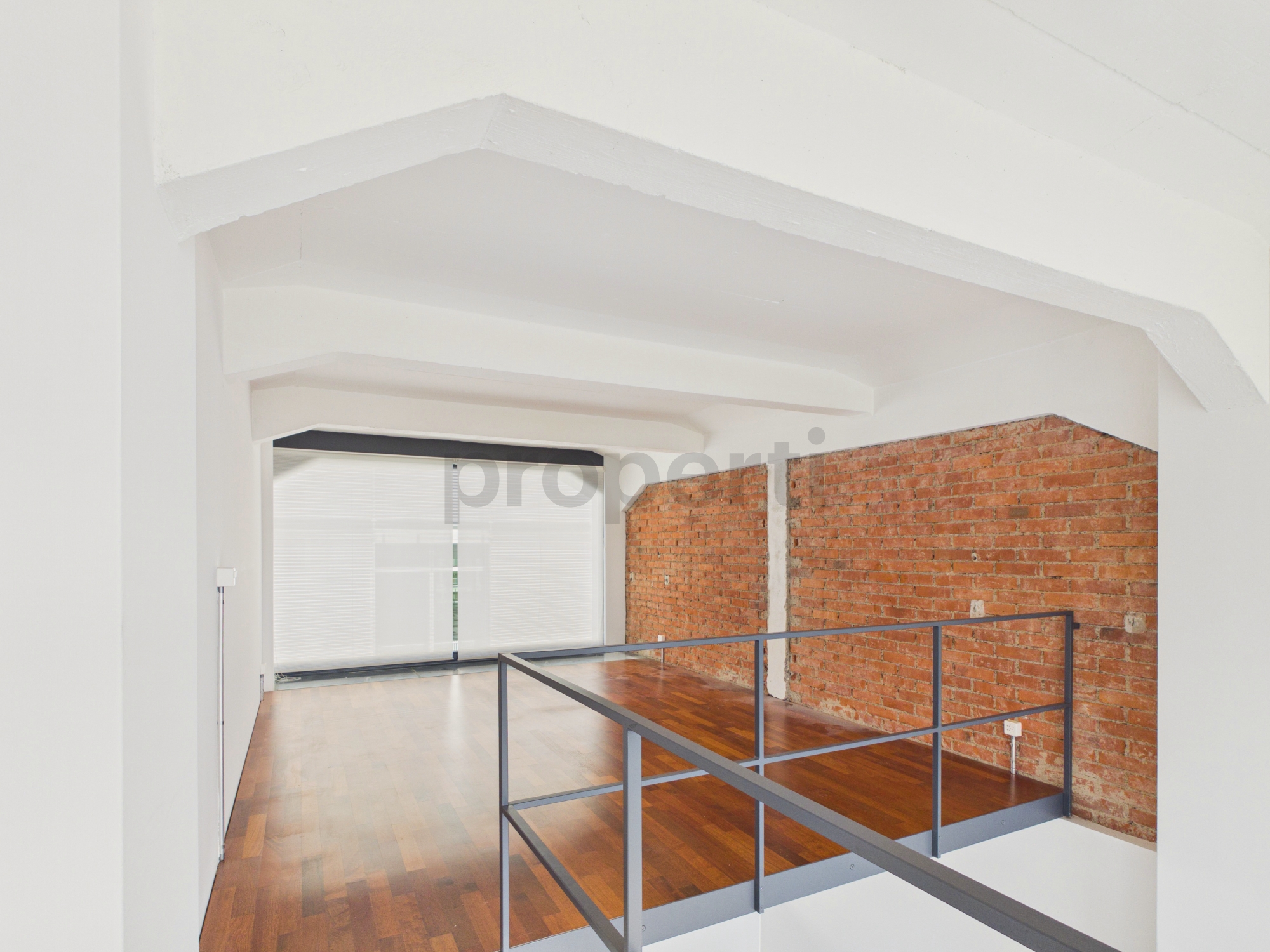 Luftige Galerie mit Backsteinwand