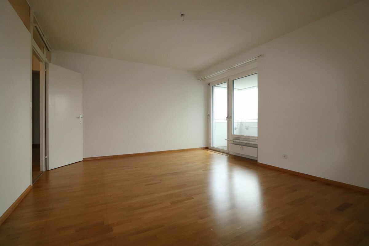 Leerer Wohnraum mit Balkonzugang