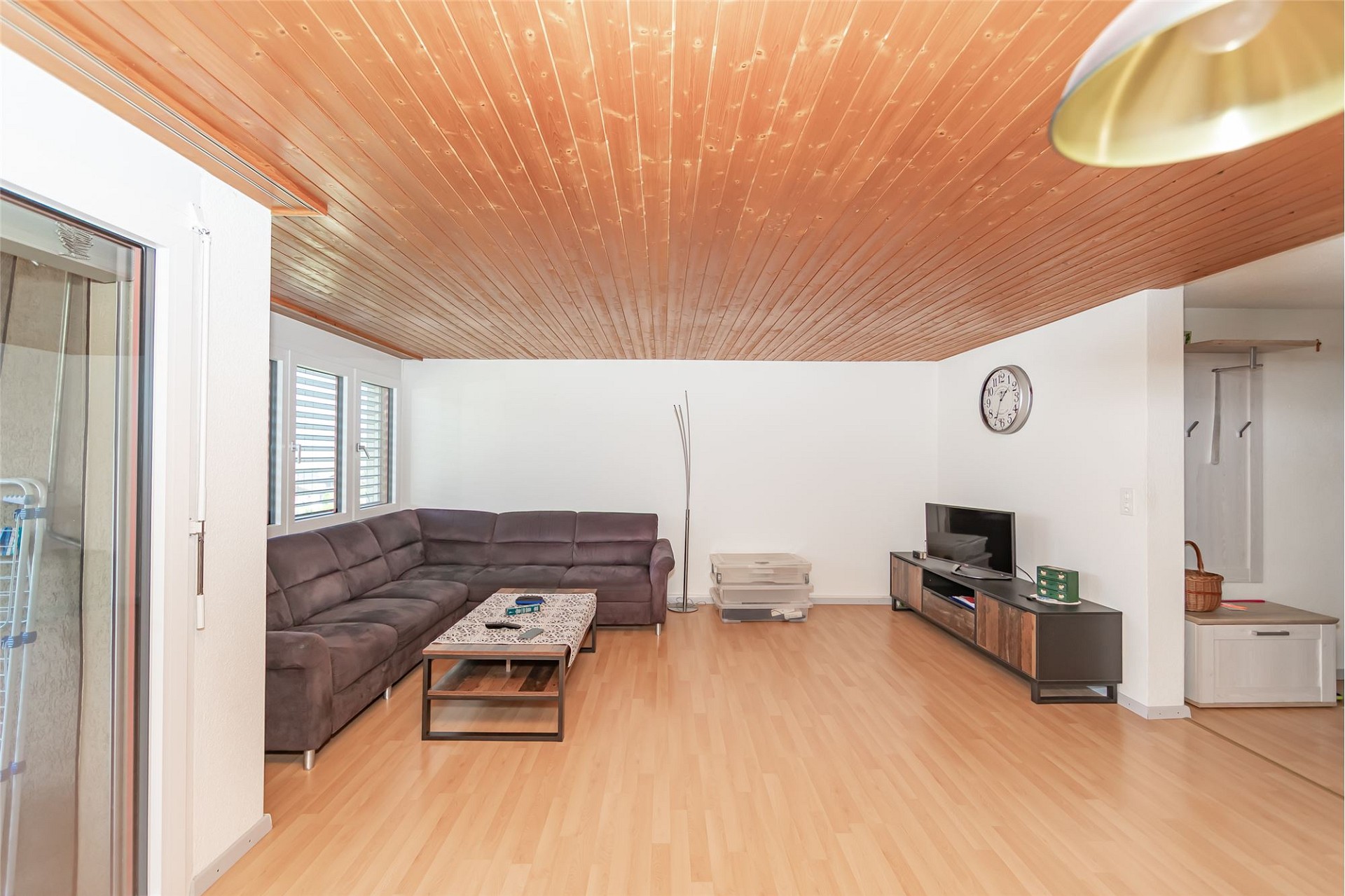 Wohnzimmer mit Holzdecke und Laminatboden