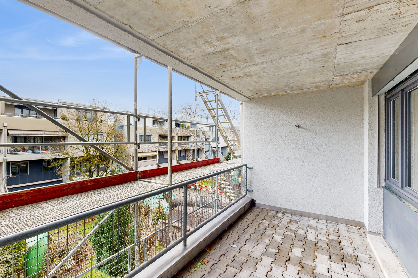 Balkon mit Gerüst und Blick auf Wohngebäude